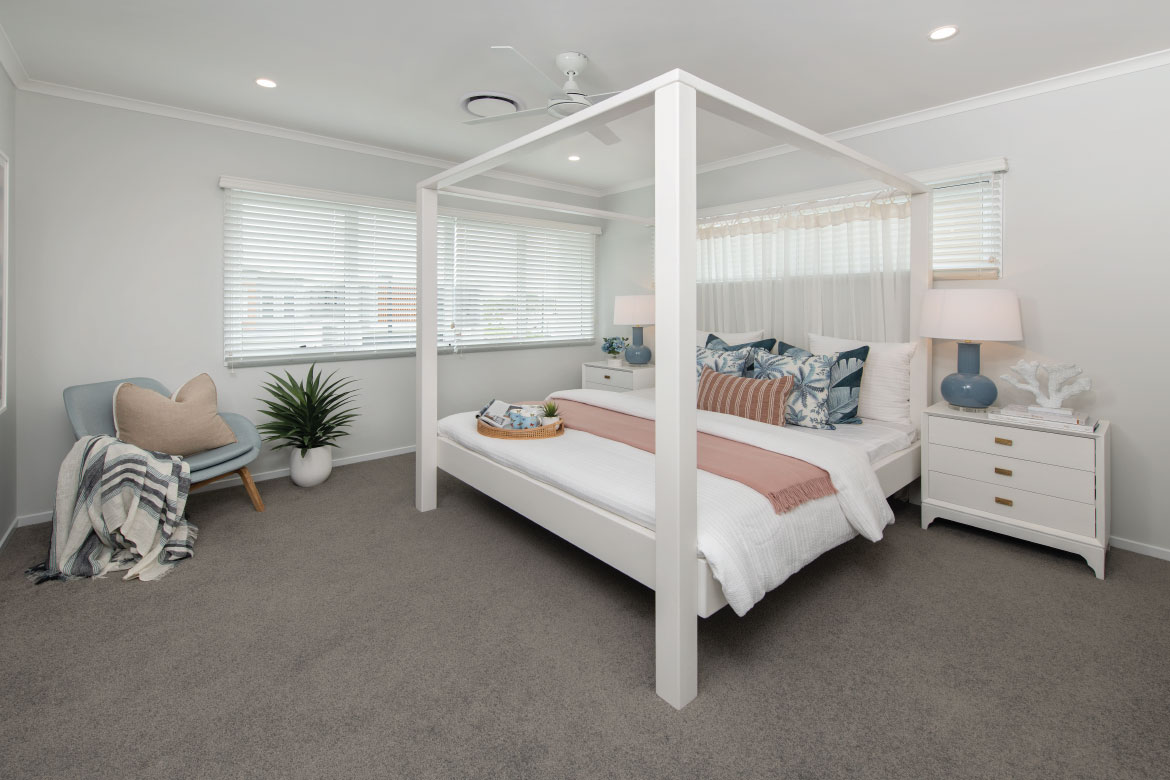 Bright a light master bedroom with pink and blue accents