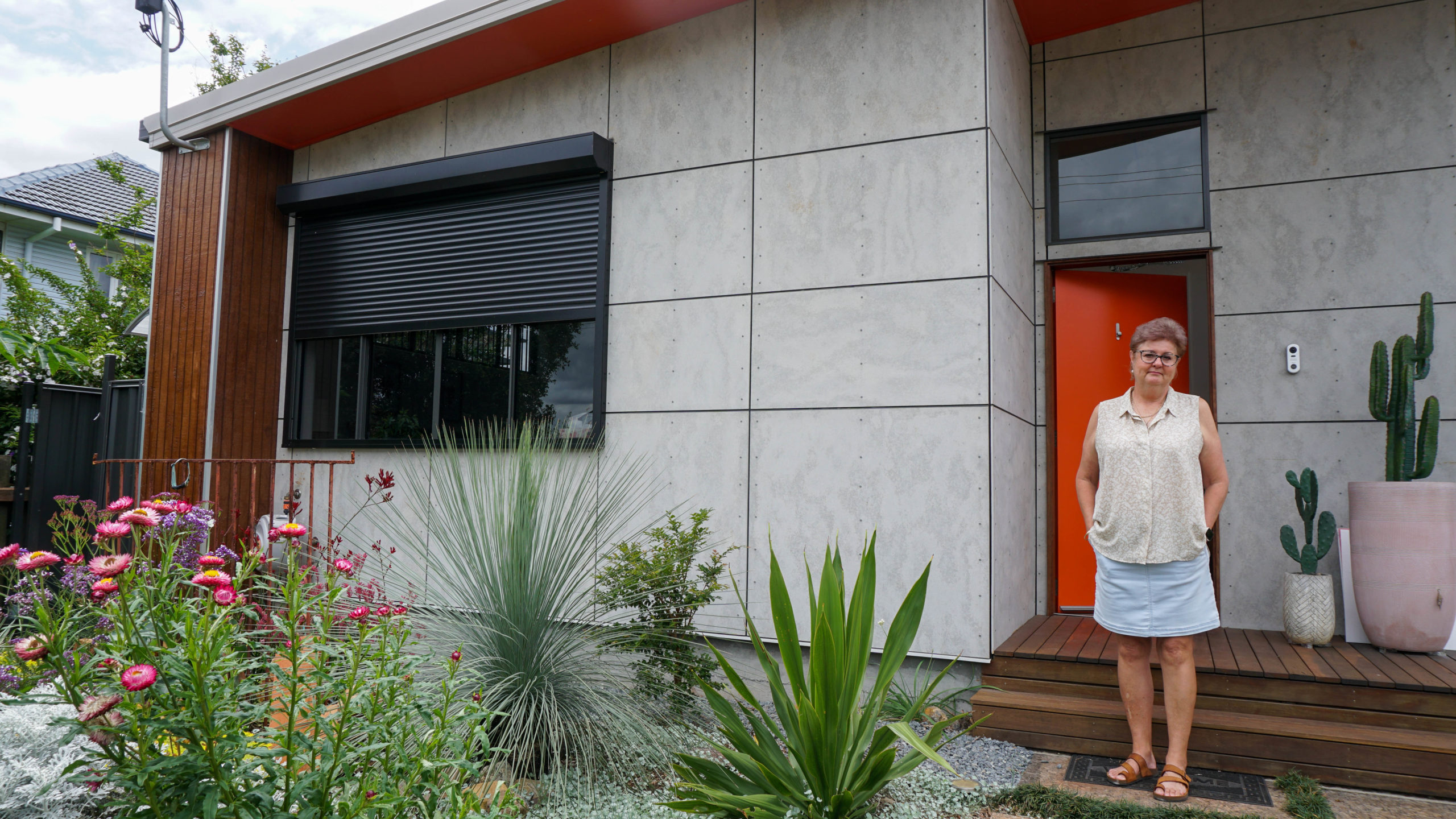 Redback customer stands outside her home
