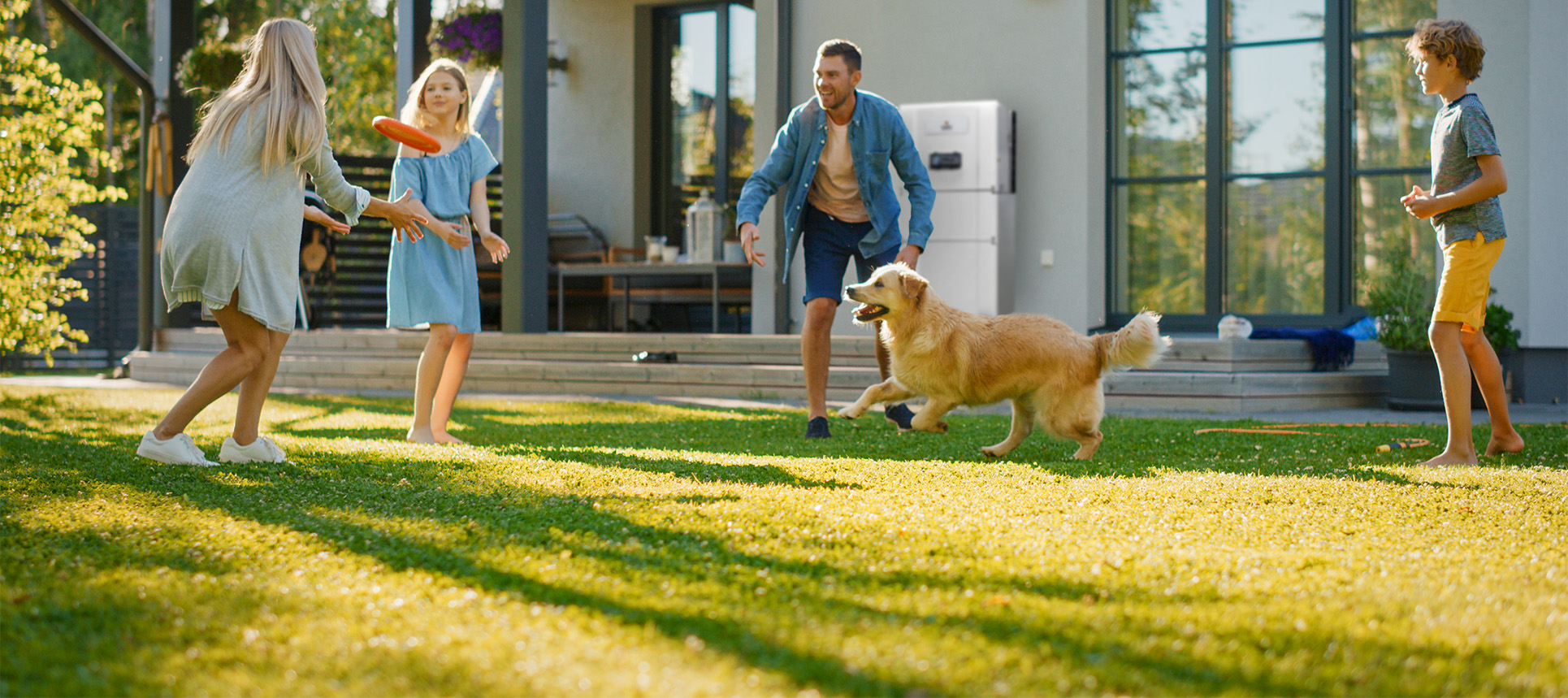 Family in garden with a Solar Battery visible in the back