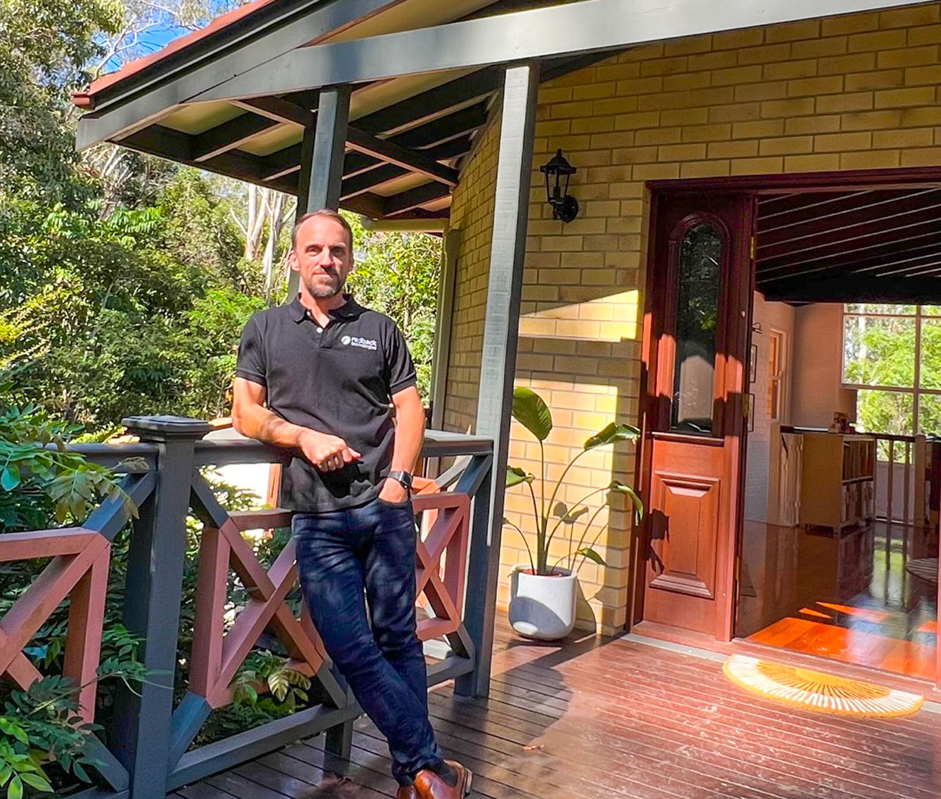 Simon standing outside of his self-sufficient home